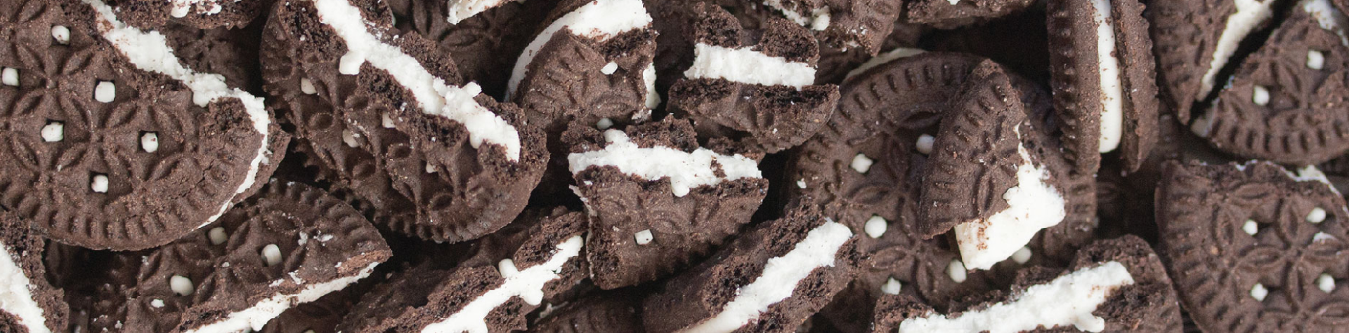 broken cookies and cream cookies piled up to create a delicious looking banner image