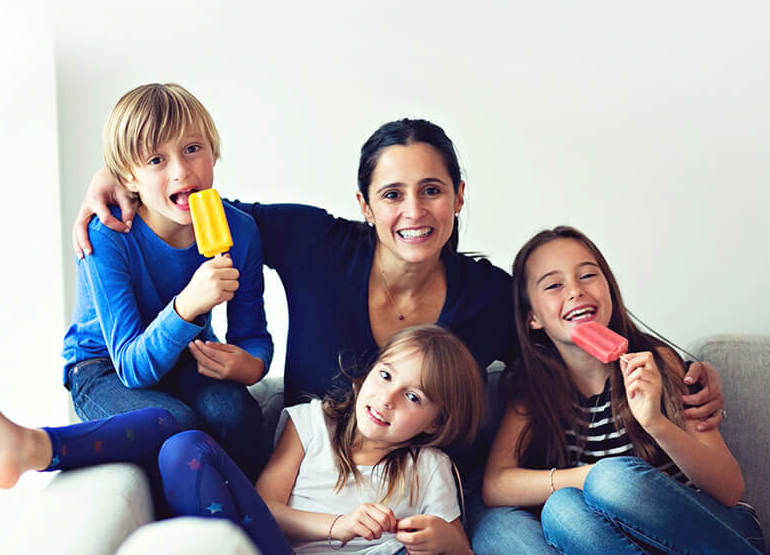 Chloe and her kids hugging holding pops